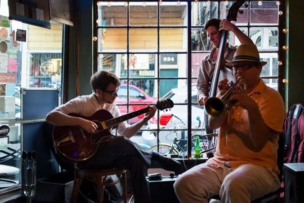 Jazz band playing in front of a window
